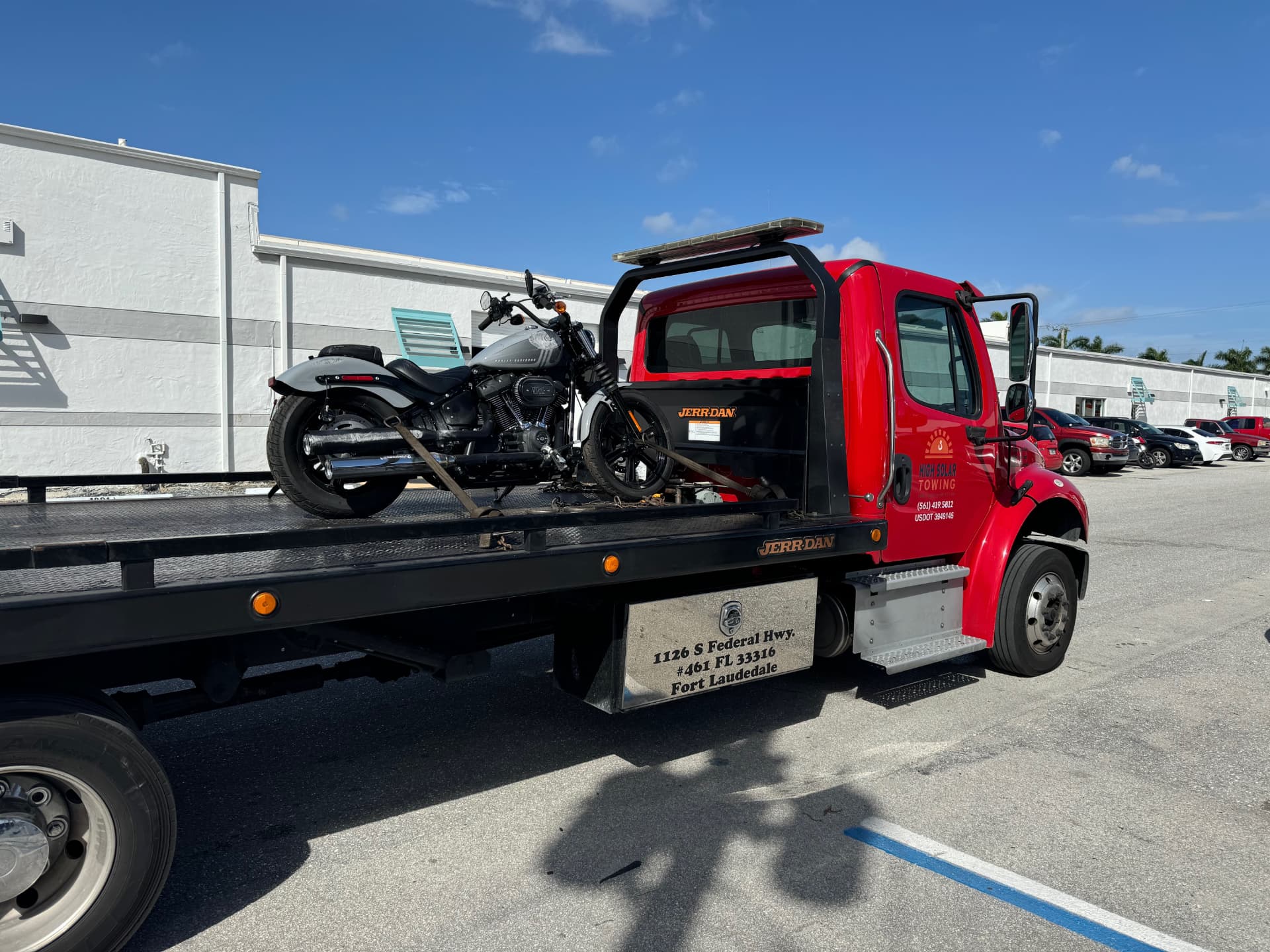 High Solar Towing flatbed transporting a motorcycle in Delray Beach