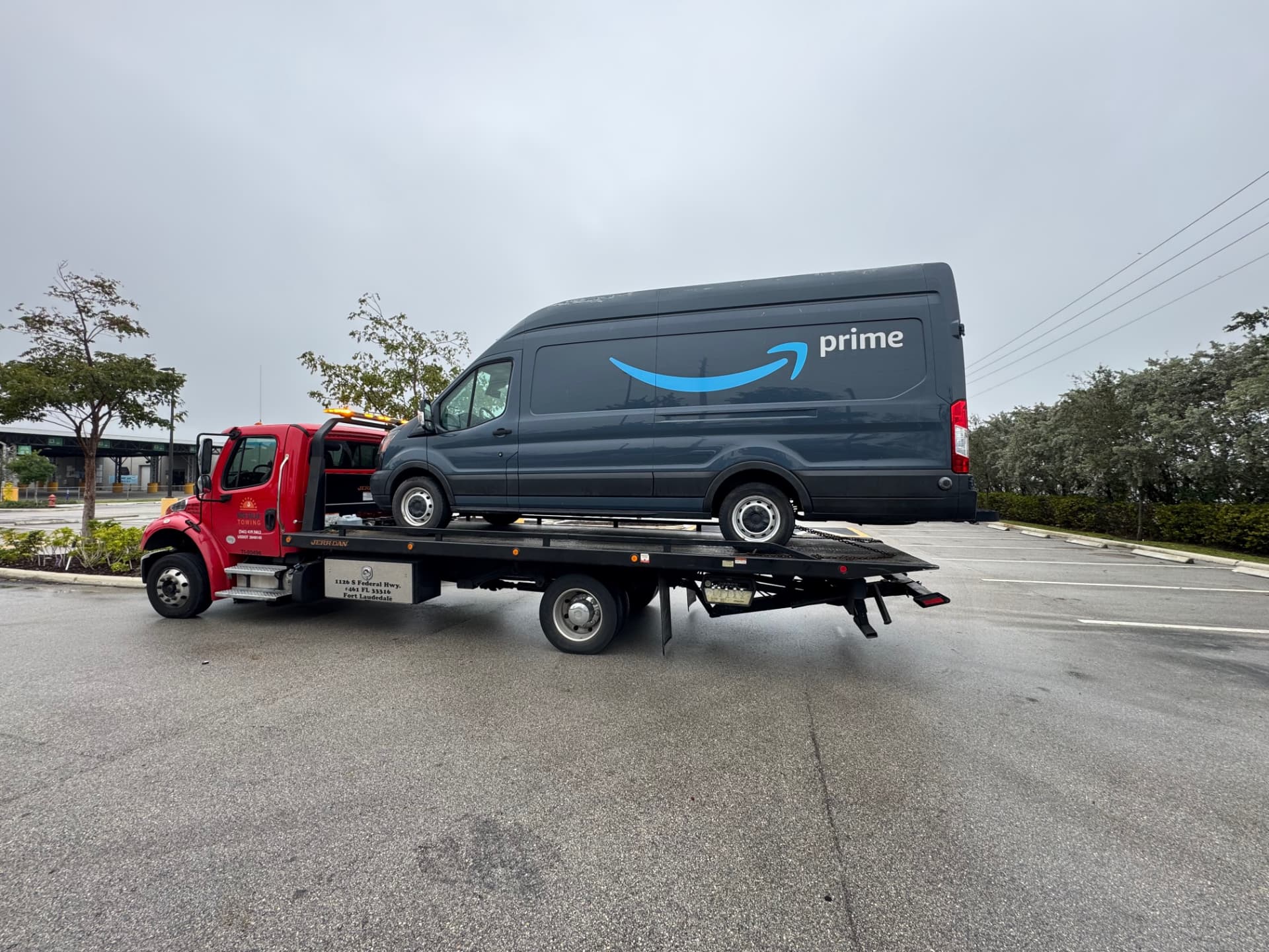 High Solar Towing flatbed transporting a large delivery van in Delray Beach