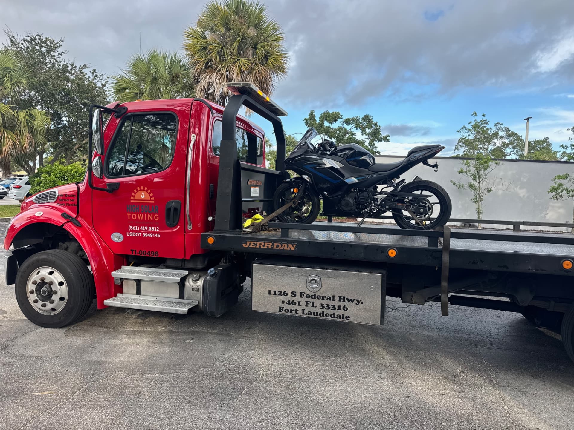 High Solar Towing flatbed carrying a motorcycle in Delray Beach, FL