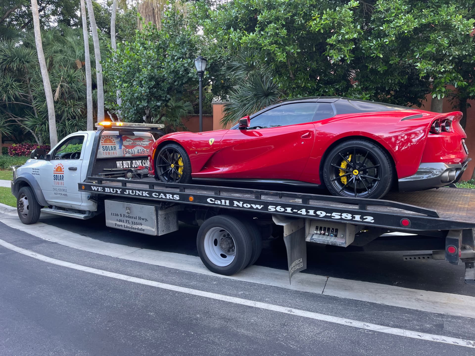 High Solar Towing truck carrying a Ferrari in Delray Beach
